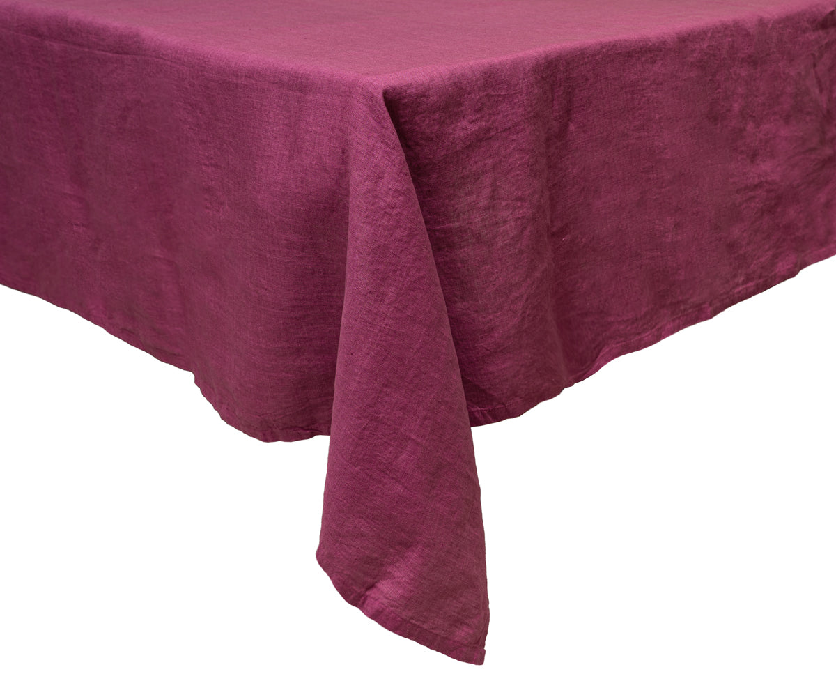 Elegant fuchsia linen tablecloth covering a rectangular table. Elegant fuchsia linen tablecloth covering a rectangular table.