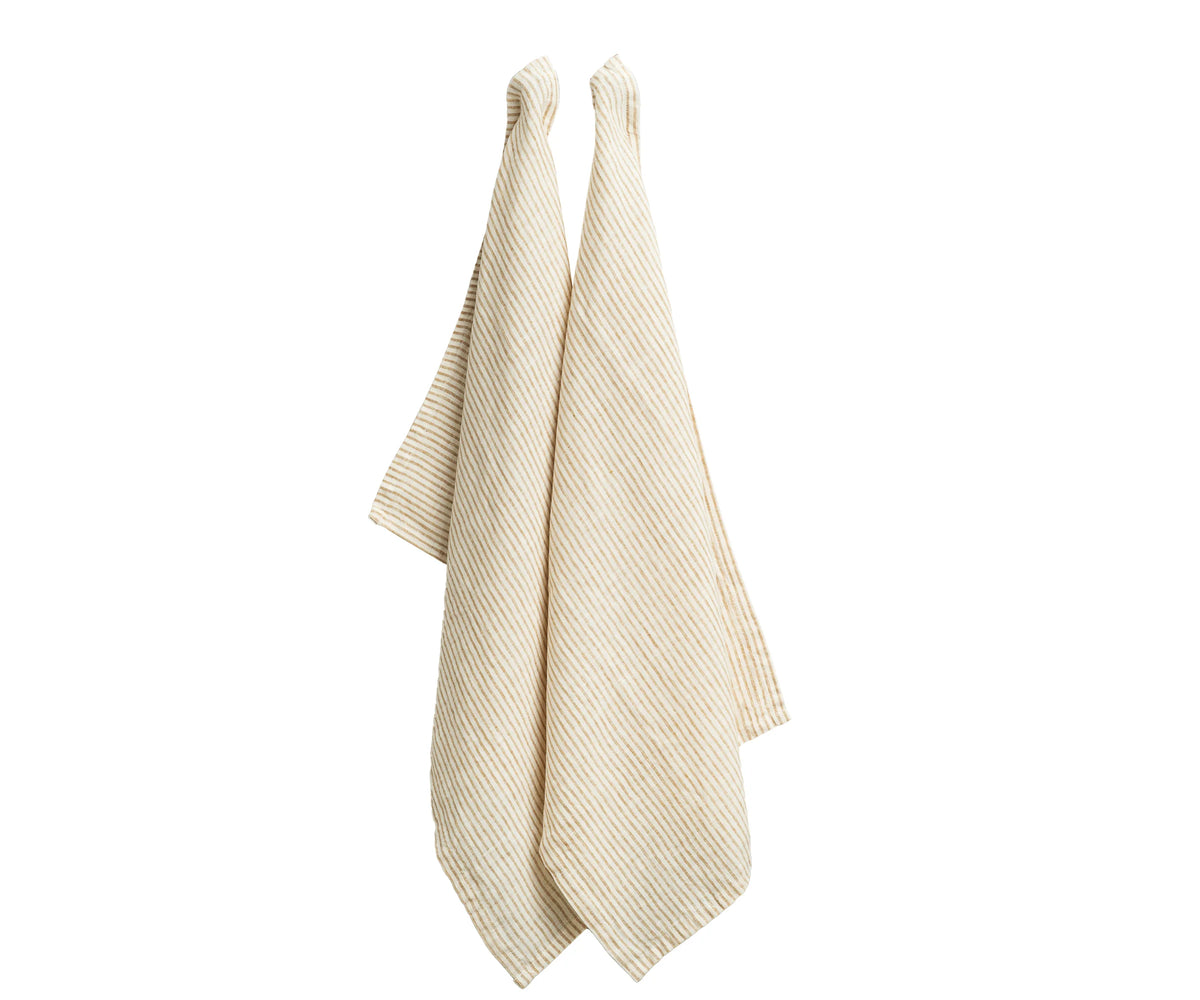 Set of 6 natural striped linen kitchen towels folded on a wooden countertop Set of 6 natural striped linen kitchen towels folded on a wooden countertop