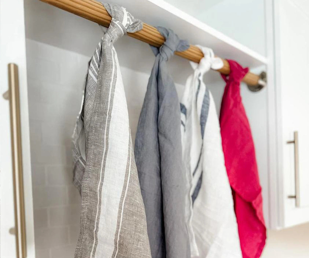 Set of linen towels neatly folded, highlighting natural texture and soft finish Set of linen towels neatly folded, highlighting natural texture and soft finish