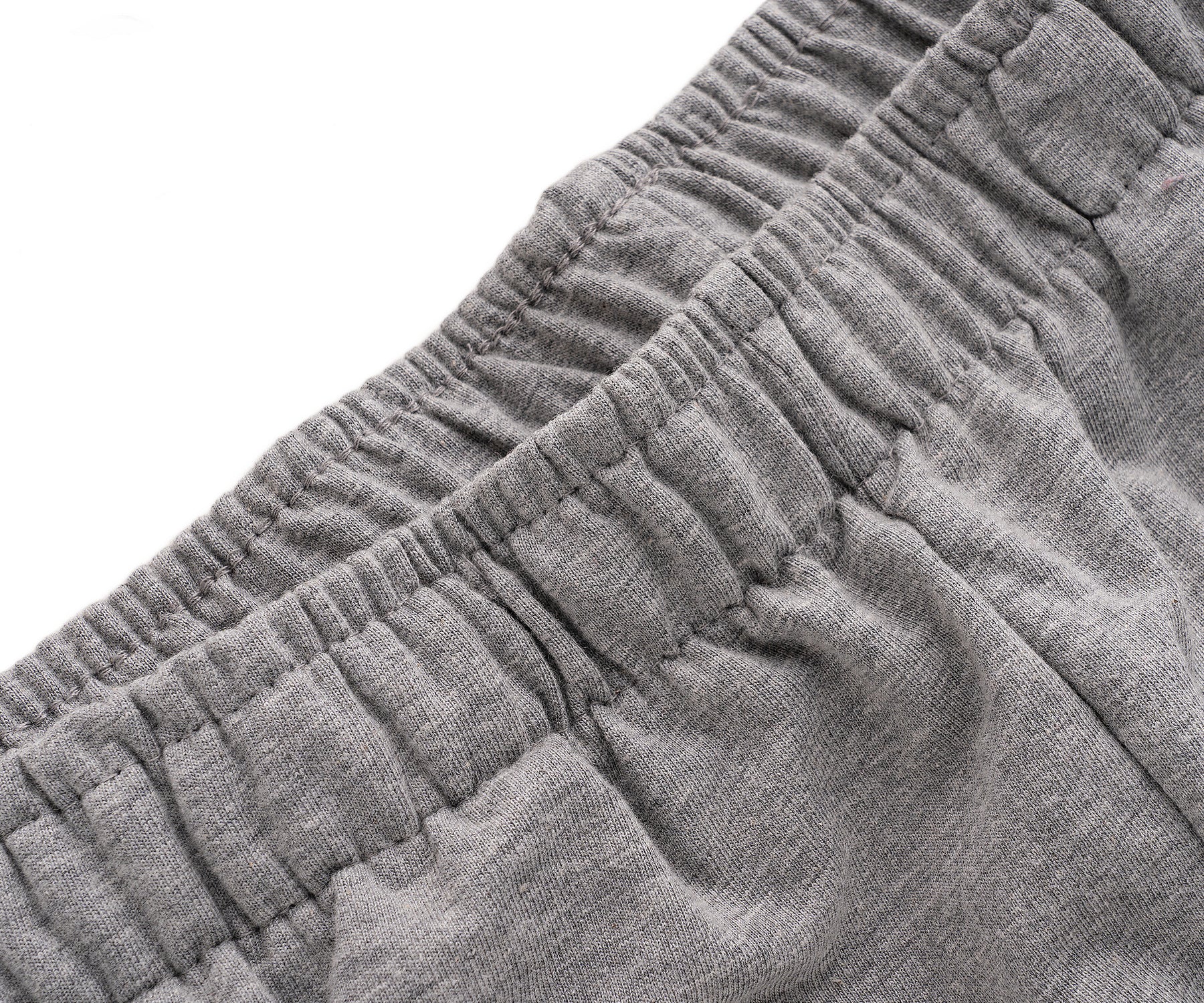Close-up of gray shorts fabric with a textured pattern on a white background Close-up of gray shorts fabric with a textured pattern on a white background