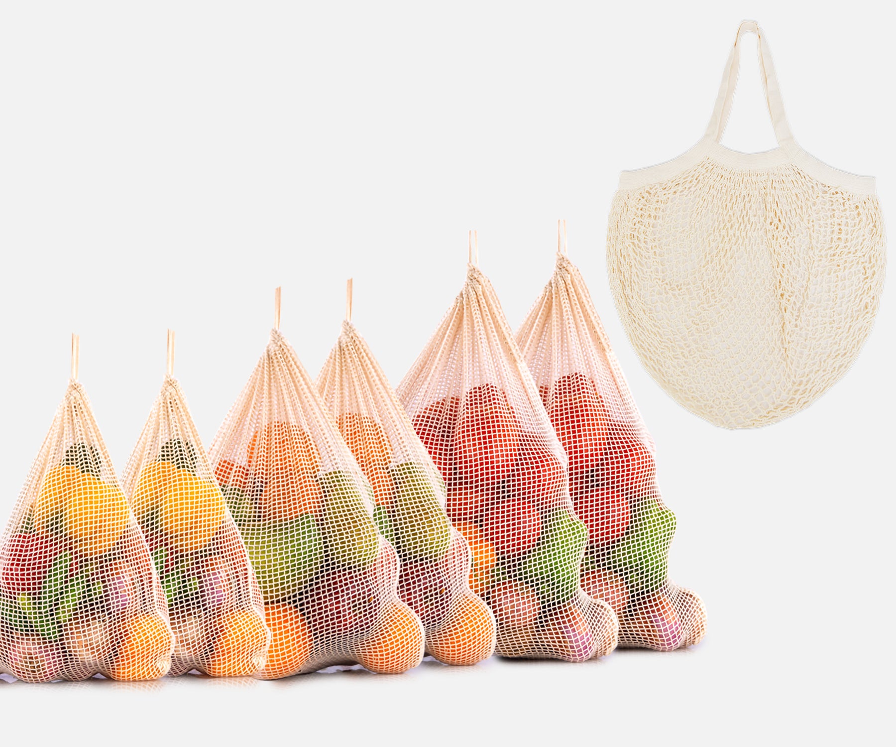 Five string mesh bags each containing different fruits and vegetables Five string mesh bags each containing different fruits and vegetables