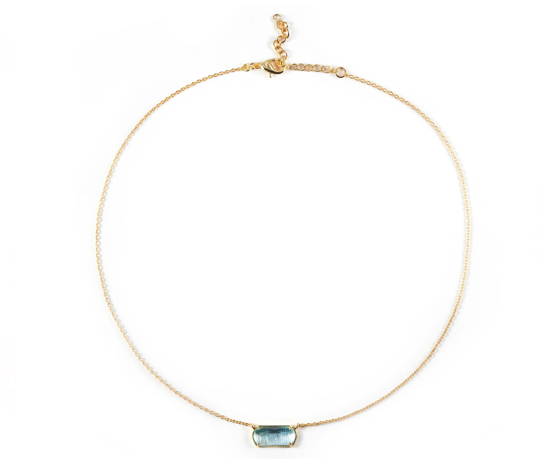 A gold necklace featuring blue stone necklace. A gold necklace featuring blue stone necklace.