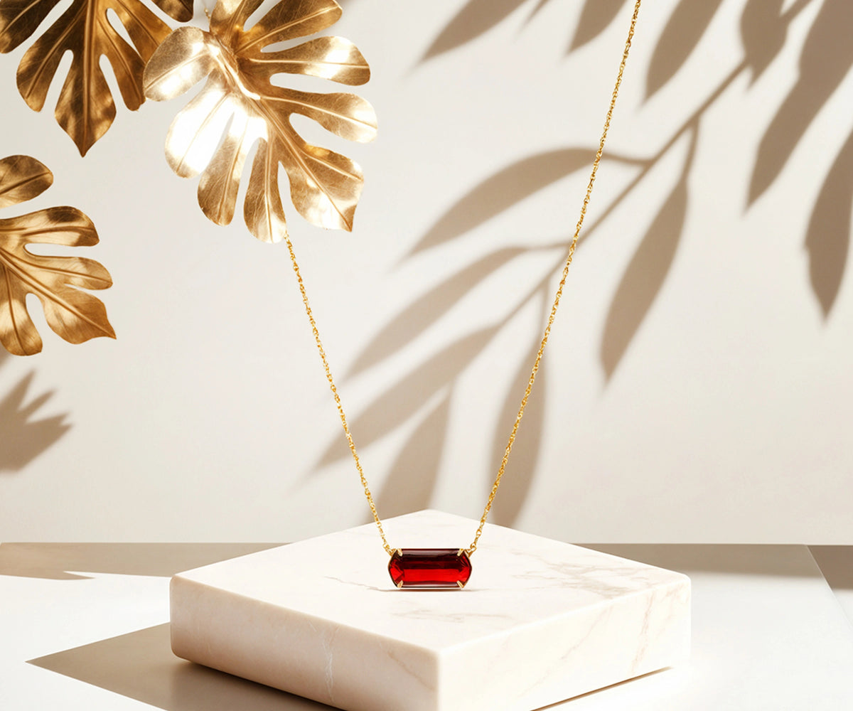 Stylish gold necklace with red pendant. Stylish gold necklace with red pendant.