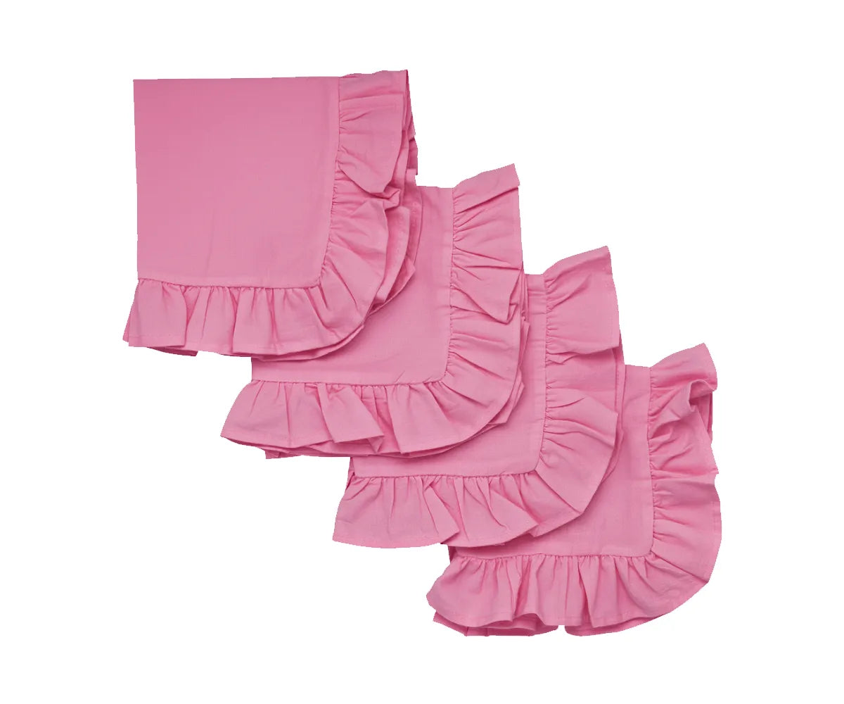 Pink ruffle-trimmed cotton napkins set neatly folded on a dining table Pink ruffle-trimmed cotton napkins set neatly folded on a dining table