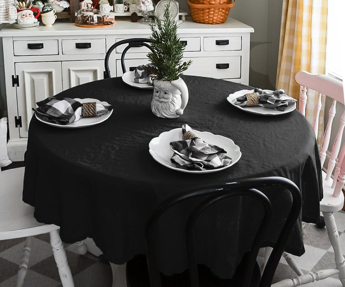 Modern black round cotton tablecloth paired with white napkins Modern black round cotton tablecloth paired with white napkins