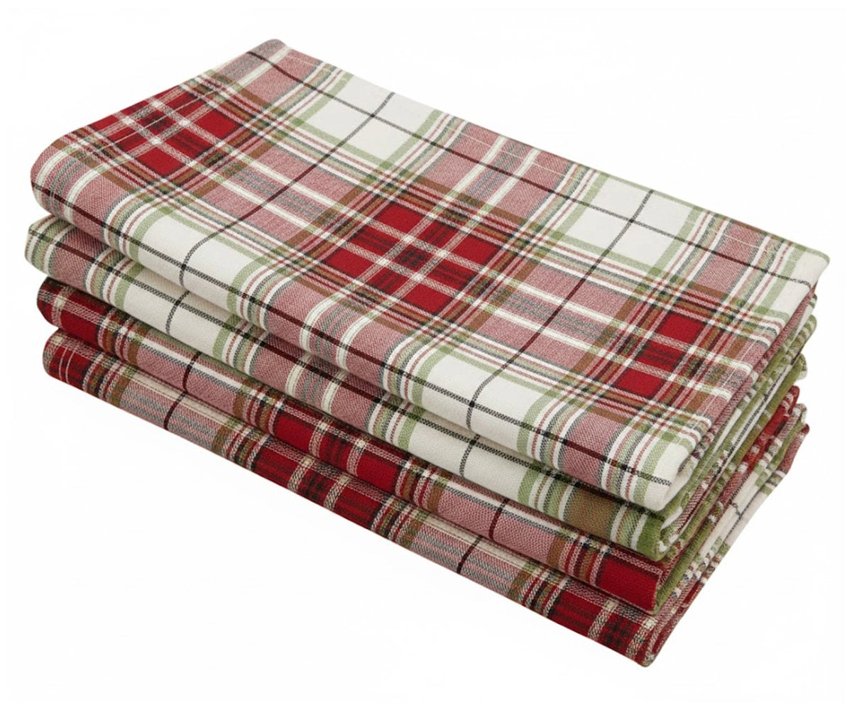 Classic red plaid cotton napkins folded neatly beside matching red tartan tablecloth Classic red plaid cotton napkins folded neatly beside matching red tartan tablecloth