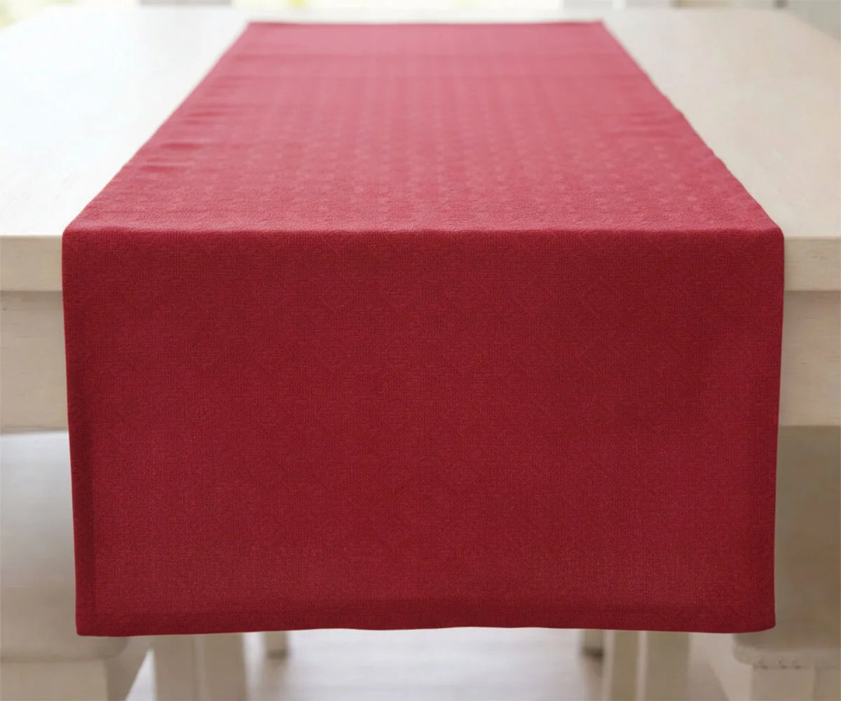 Solid red tablecloth covering a rectangular table Solid red tablecloth covering a rectangular table