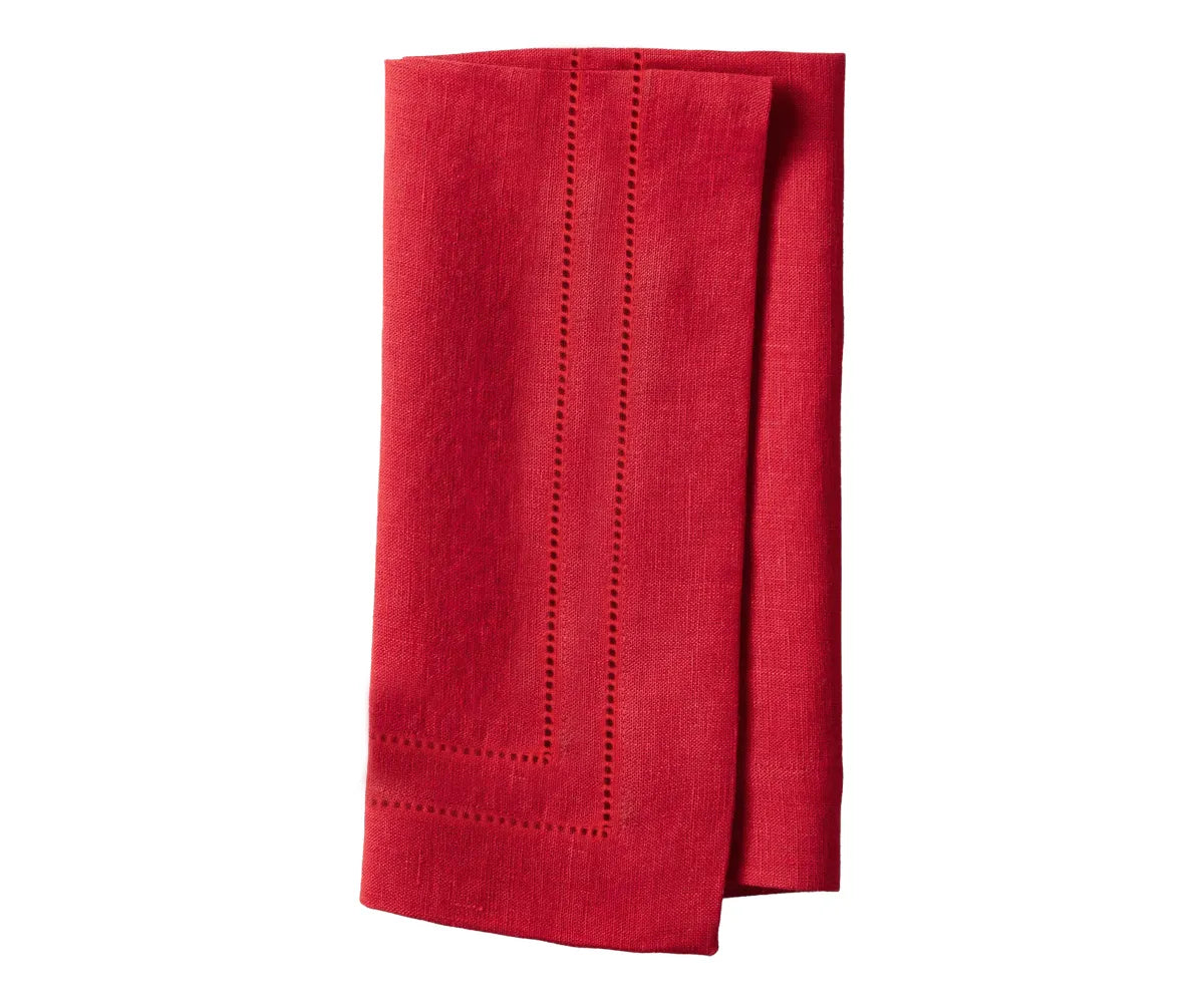 Elegant red hemstitch linen napkins neatly folded on a dining table Elegant red hemstitch linen napkins neatly folded on a dining table