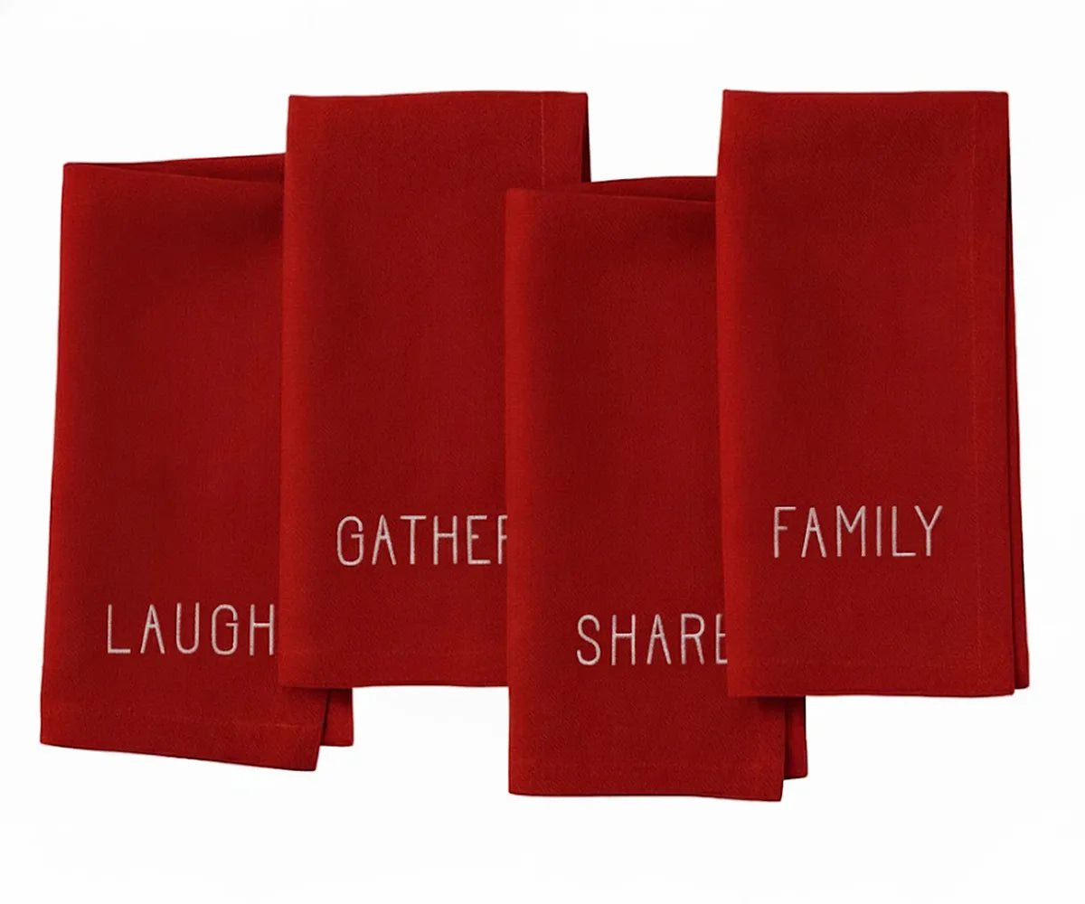 Red embroidered cotton napkin with white lettering — festive cloth dinner napkin for holiday dining table. Red embroidered cotton napkin with white lettering — festive cloth dinner napkin for holiday dining table.