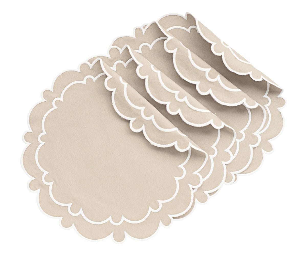 Light beige round scalloped placemat on dining table Light beige round scalloped placemat on dining table