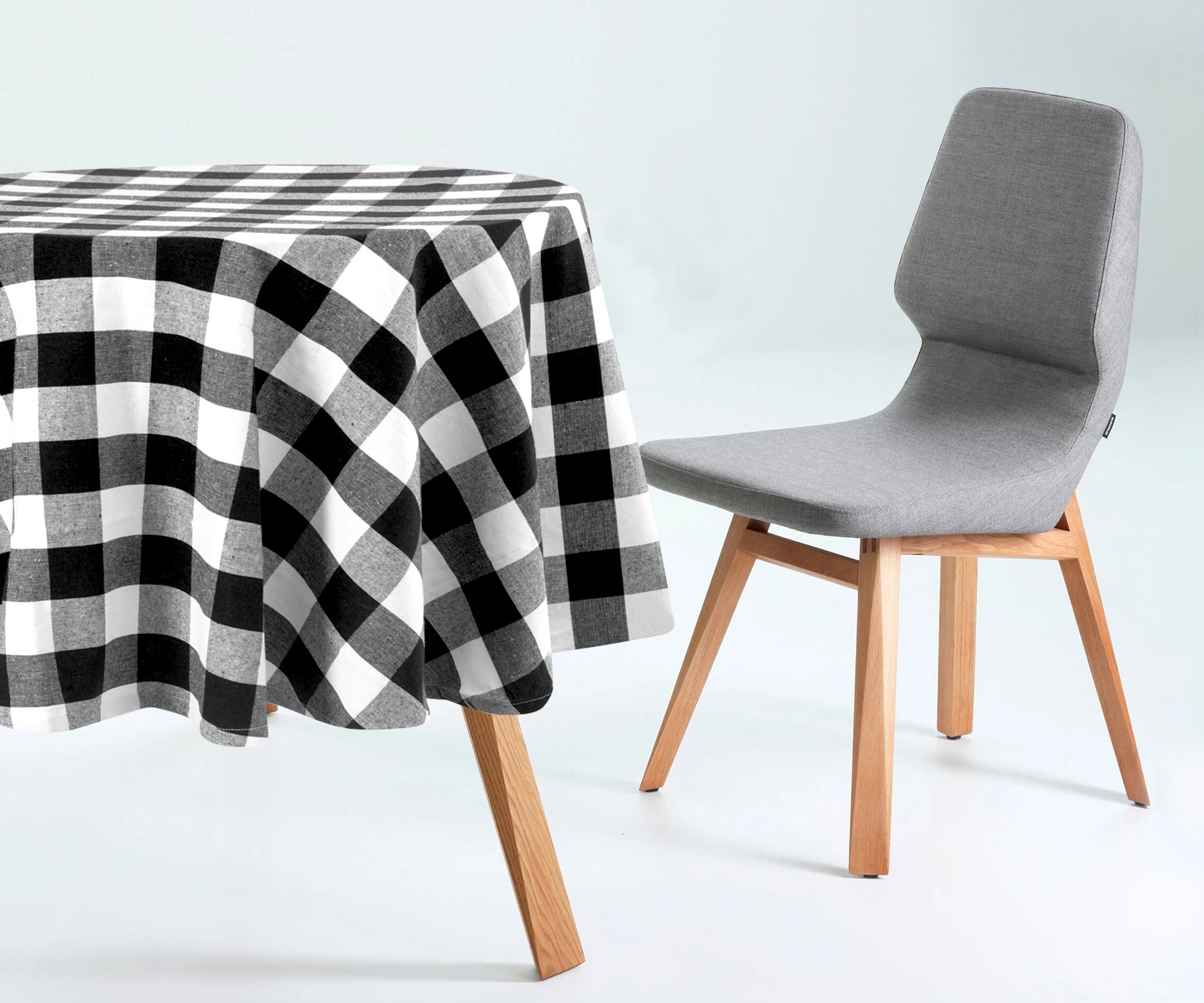 Round plaid tablecloth, with its cozy checkered pattern, sets a relaxed and inviting tone for meals. Round plaid tablecloth, with its cozy checkered pattern, sets a relaxed and inviting tone for meals.