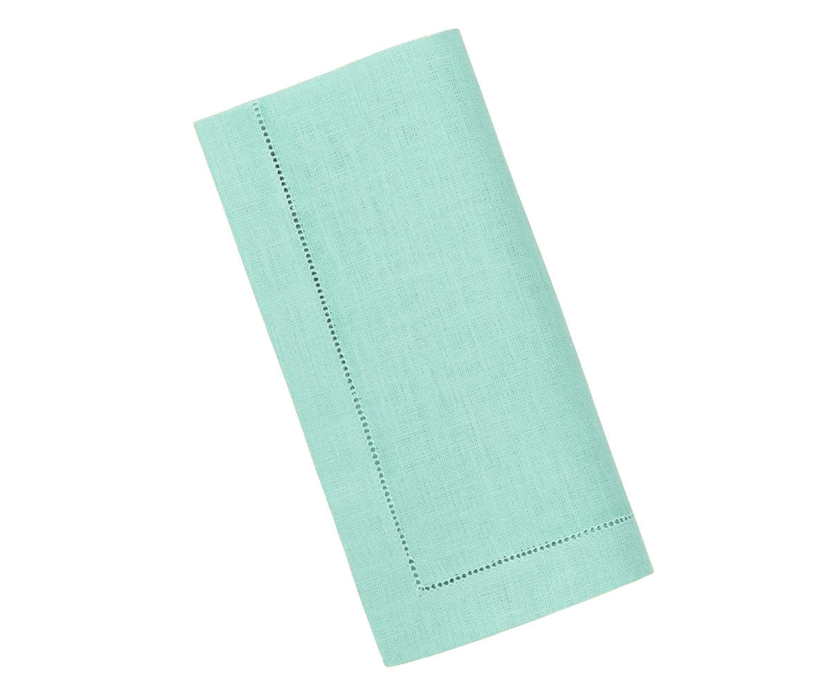 Elegant hemstitched linen napkin in seafoam green, neatly folded to highlight detailed stitching and smooth linen fabric. Elegant hemstitched linen napkin in seafoam green, neatly folded to highlight detailed stitching and smooth linen fabric.