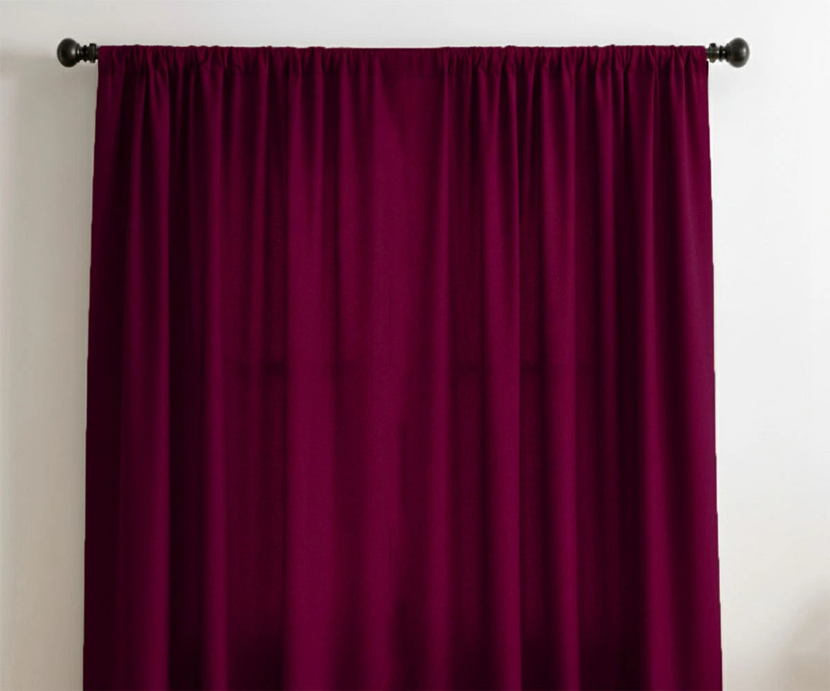 Burgundy velvet curtains hanging on black curtain rod in modern living room Burgundy velvet curtains hanging on black curtain rod in modern living room