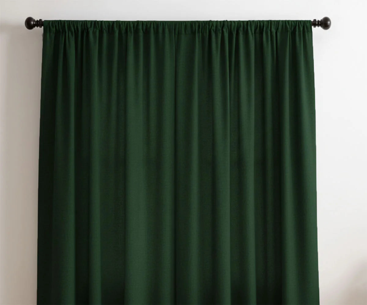 Green linen curtains draped in a bright living room, allowing natural light to filter through. Green linen curtains draped in a bright living room, allowing natural light to filter through.