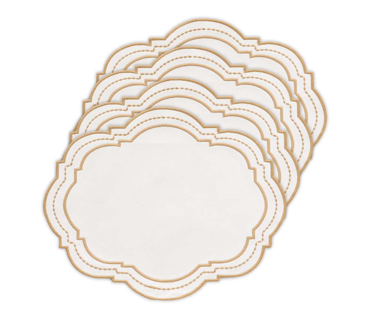 Oval placemat with a dotted pattern in white and beige, styled under sleek tableware. Oval placemat with a dotted pattern in white and beige, styled under sleek tableware.