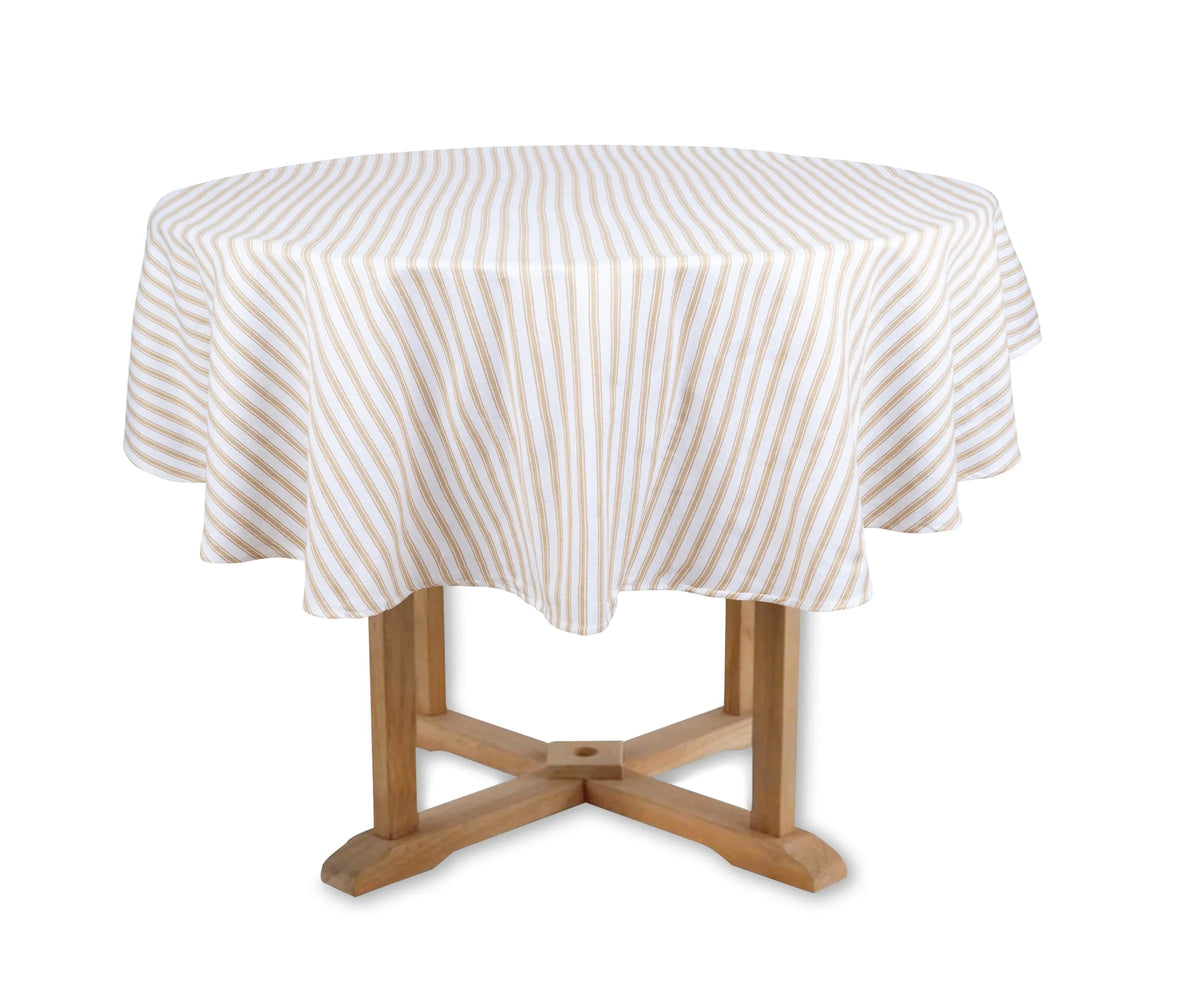 Beige and white striped round cotton tablecloth on a dining table Beige and white striped round cotton tablecloth on a dining table