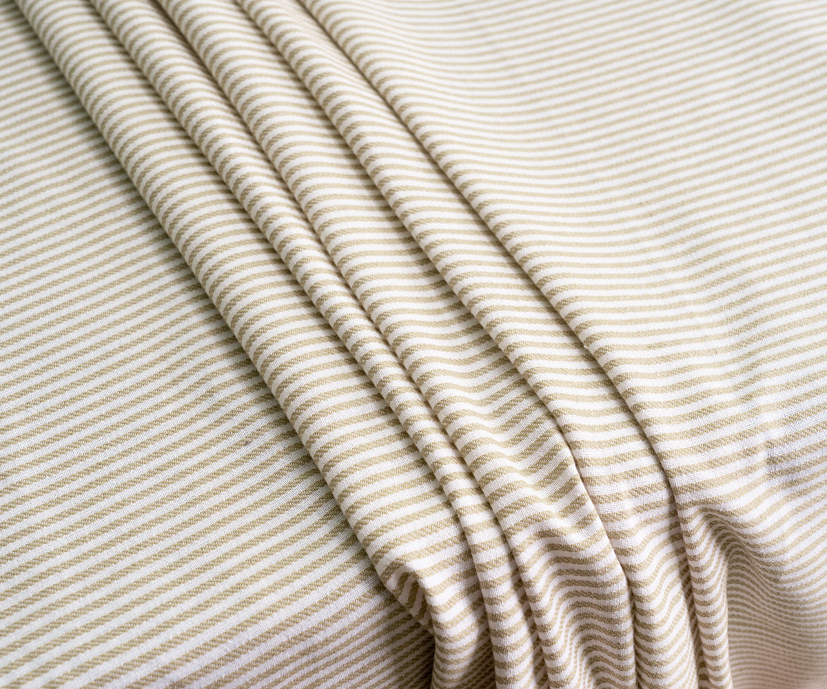 Beige tablecloth adorned with navy and red color stripes for a balanced and chic dining look. Beige tablecloth adorned with navy and red color stripes for a balanced and chic dining look.