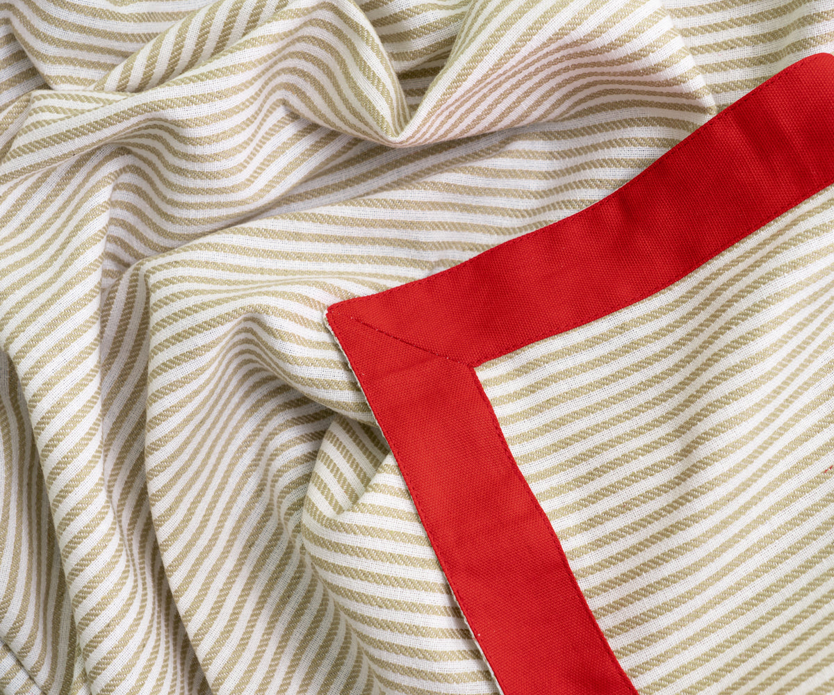 Pattern tablecloths in beige with a red color border, creating a sophisticated dining room setting. Pattern tablecloths in beige with a red color border, creating a sophisticated dining room setting.