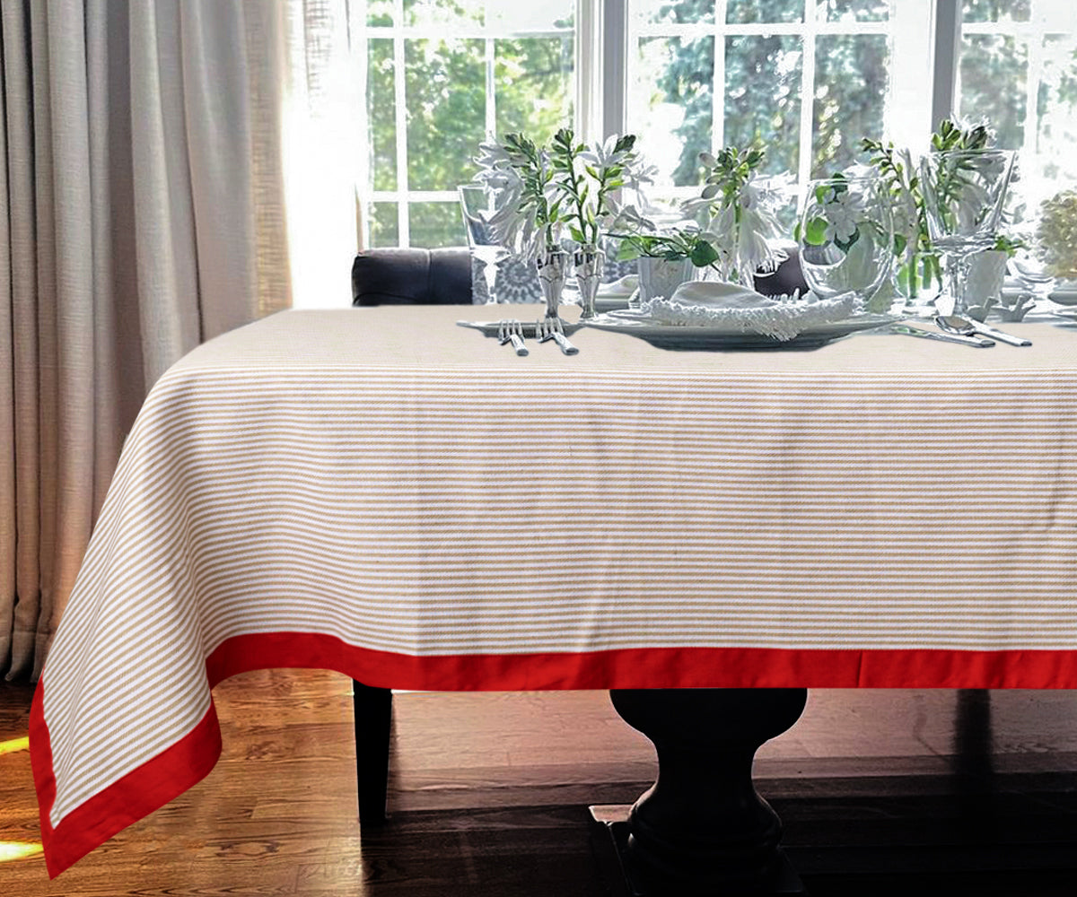 Pattern tablecloths in beige with a red color border, creating a sophisticated dining room setting. Pattern tablecloths in beige with a red color border, creating a sophisticated dining room setting.