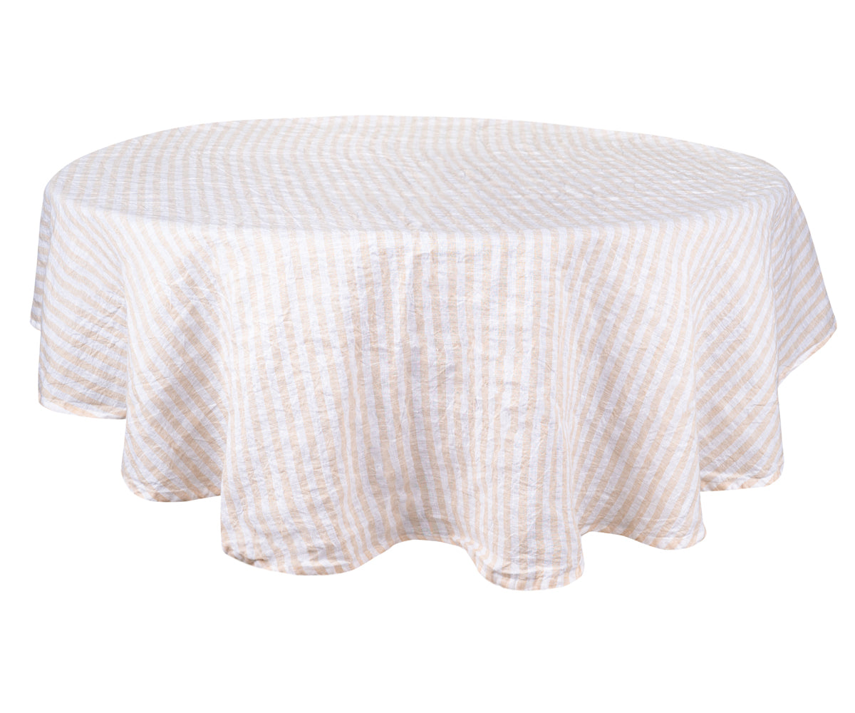 A round linen tablecloth in a calming beigehue. A round linen tablecloth in a calming beigehue.