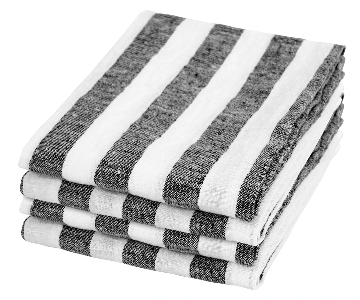 Crisp black linen napkins with fringed edges, folded neatly and ready to be used, adding a refined touch to a dining experience. Crisp black linen napkins with fringed edges, folded neatly and ready to be used, adding a refined touch to a dining experience.