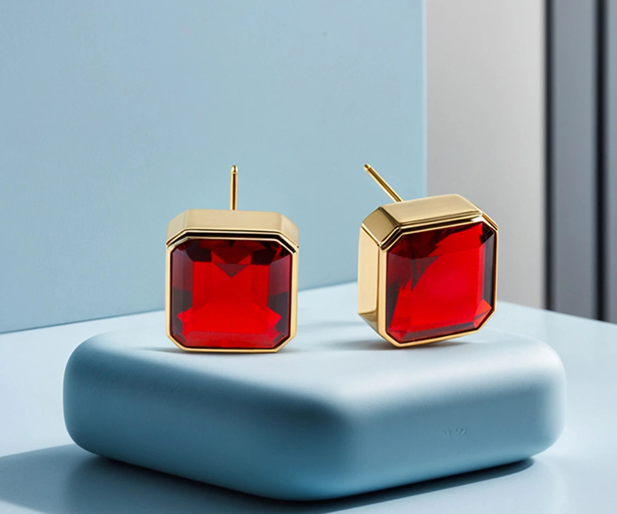 Side view of garnet earrings with secure push-back closure and 18K gold plating. Side view of garnet earrings with secure push-back closure and 18K gold plating.
