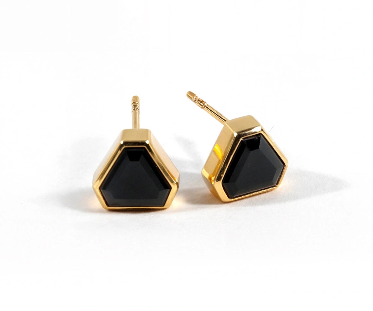 Elegant black onyx earrings with 18k yellow gold plating and secure push-back closure. Elegant black onyx earrings with 18k yellow gold plating and secure push-back closure.