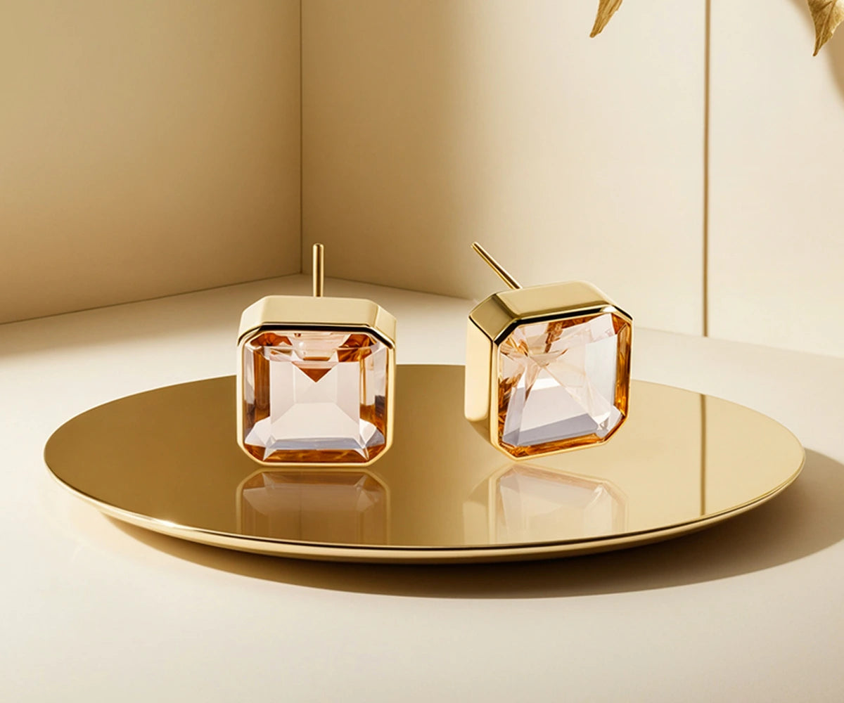 Elegant gold morganite earrings featuring a sparkling Asscher-cut blush gemstone. Elegant gold morganite earrings featuring a sparkling Asscher-cut blush gemstone.