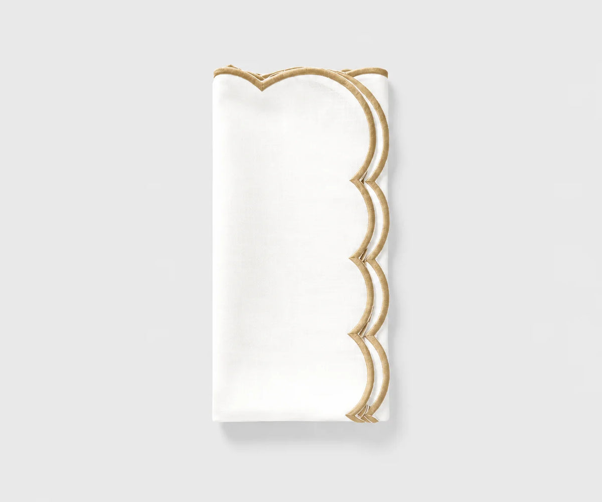 White and beige scalloped cloth napkin folded on a white background White and beige scalloped cloth napkin folded on a white background