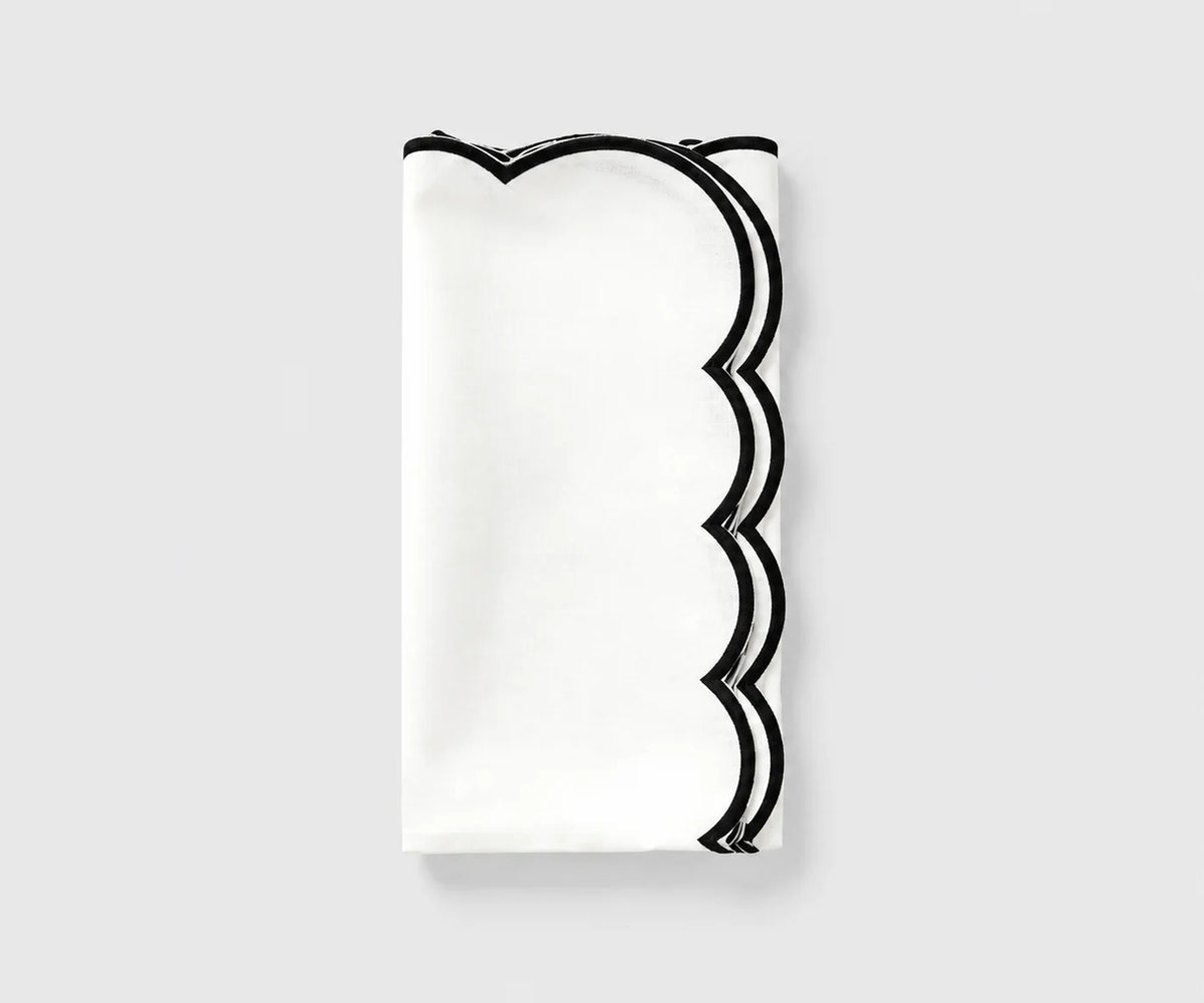 White and black scalloped cloth napkin folded on a white background White and black scalloped cloth napkin folded on a white background