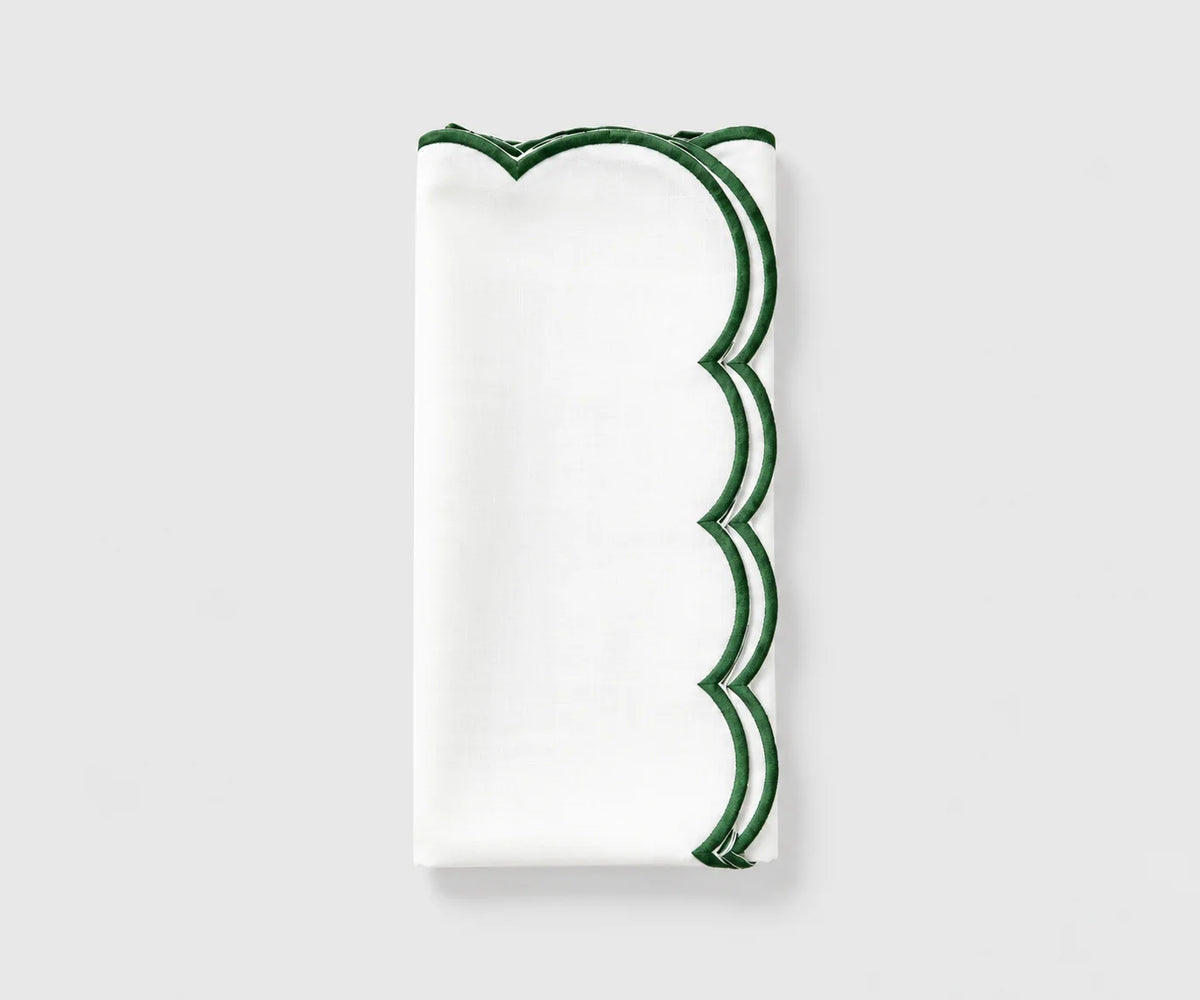 White and green scalloped cloth napkin folded on a white background White and green scalloped cloth napkin folded on a white background