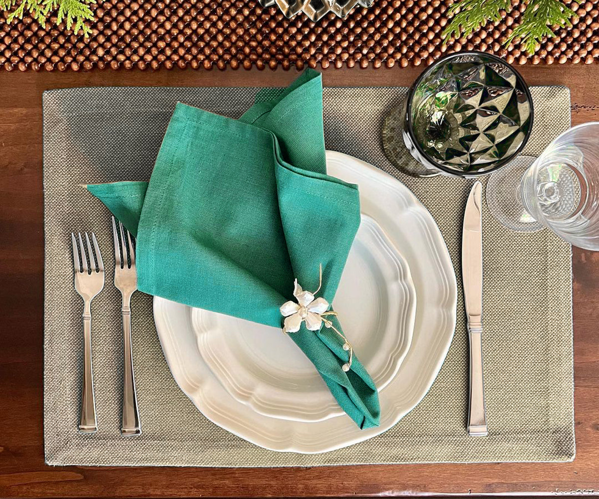 Upgrade your dining table with green fabric placemats, adding charm and protection for a delightful and stylish mealtime experience Upgrade your dining table with green fabric placemats, adding charm and protection for a delightful and stylish mealtime experience
