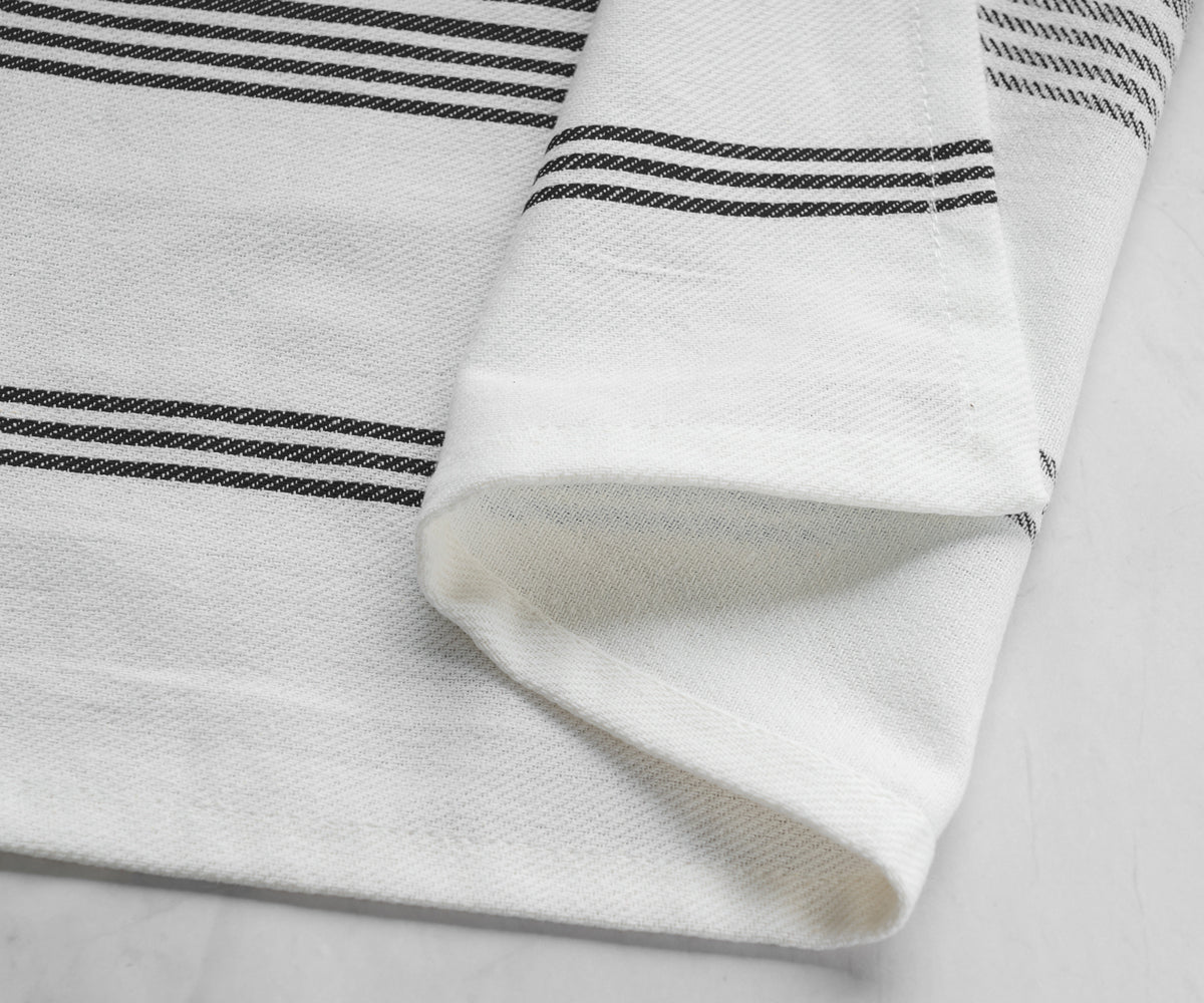 One black striped napkin laid out on a marble background One black striped napkin laid out on a marble background