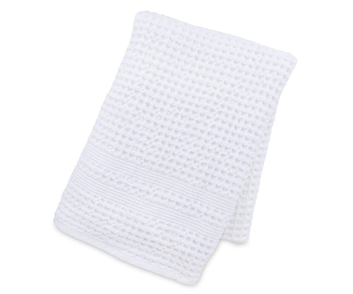 Soft waffle weave blanket draped over a couch for a modern home décor touch. Soft waffle weave blanket draped over a couch for a modern home décor touch.