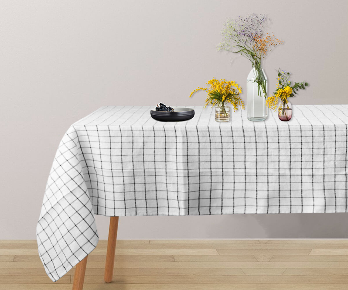 A round white linen tablecloth for a timeless appeal. A round white linen tablecloth for a timeless appeal.