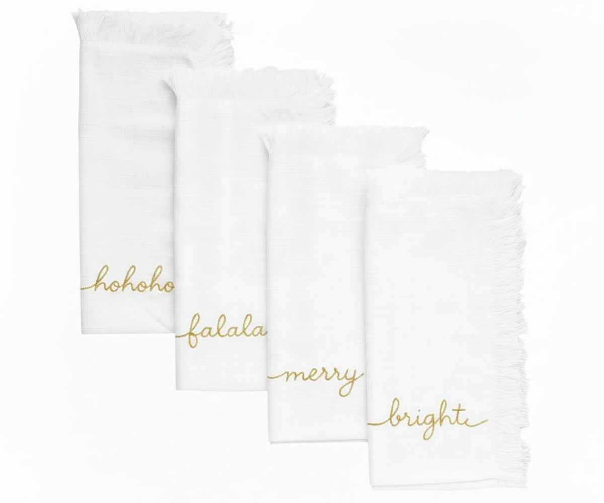 White Christmas embroidered napkins with gold lettering and fringed edges for elegant table settings White Christmas embroidered napkins with gold lettering and fringed edges for elegant table settings