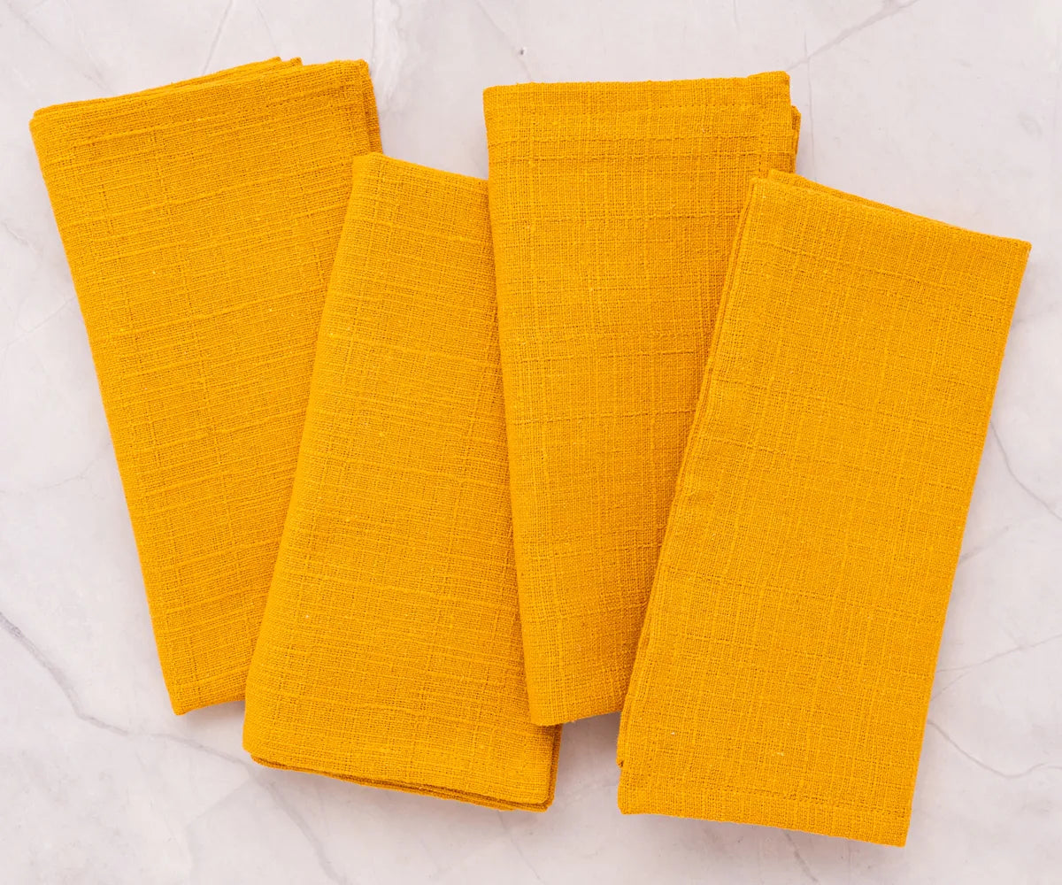 Set of soft yellow fabric napkins arranged for a festive meal. Set of soft yellow fabric napkins arranged for a festive meal.