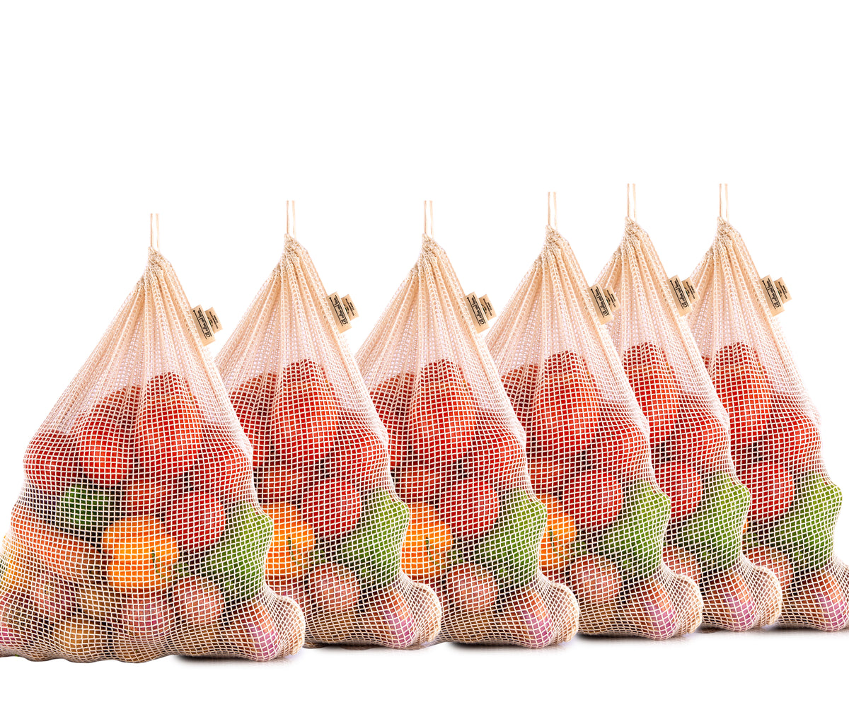 A set of six cotton string bags, each loaded with fruits and vegetables A set of six cotton string bags, each loaded with fruits and vegetables