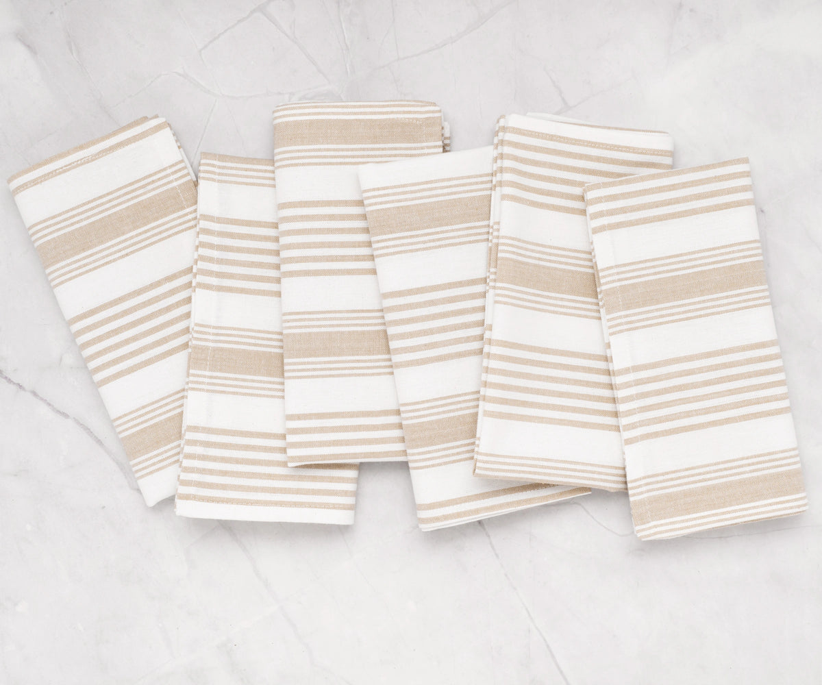 Striped cotton cloth napkins in beige, folded stack Striped cotton cloth napkins in beige, folded stack