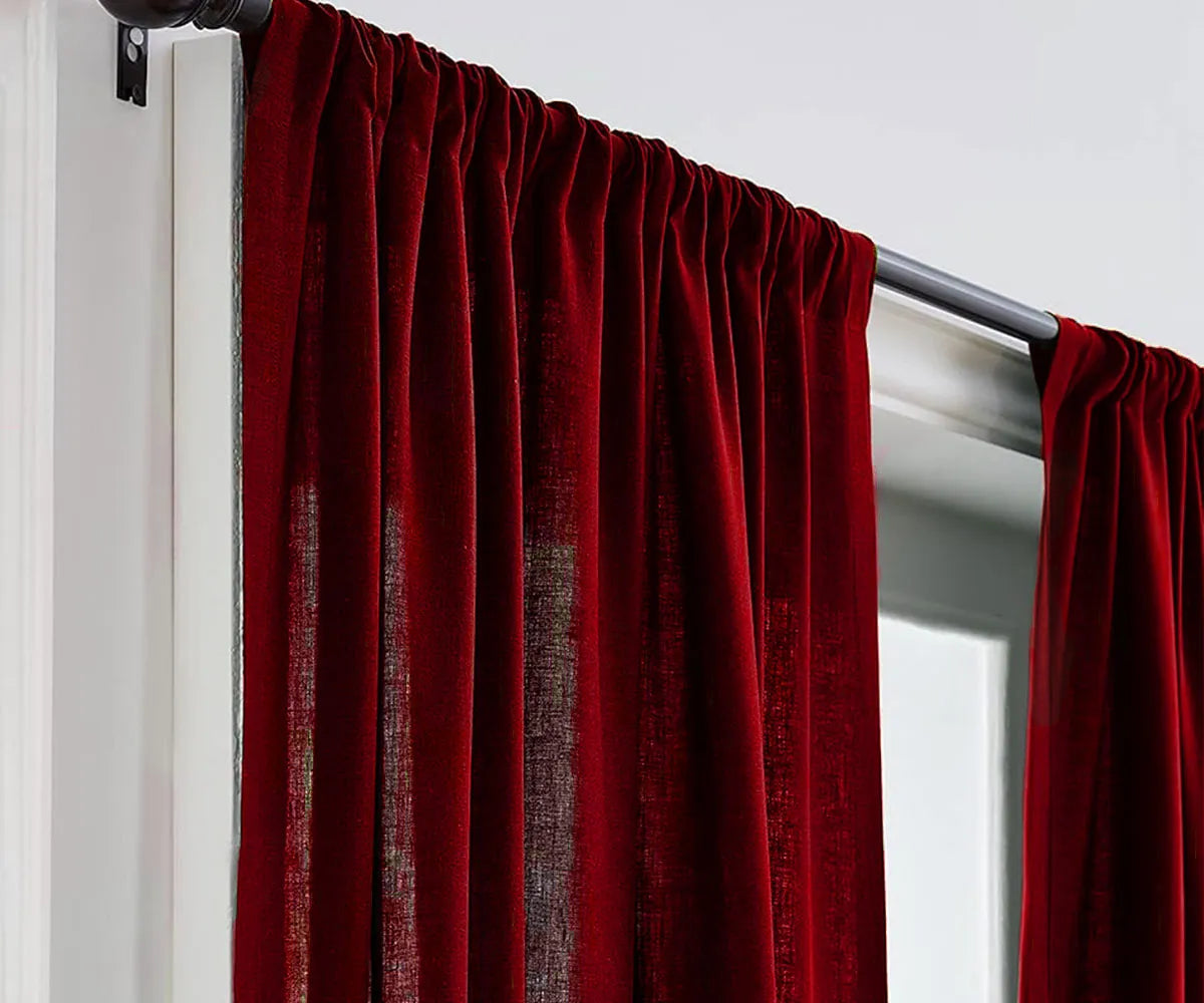 Cherry red linen curtains softly draping window Cherry red linen curtains softly draping window