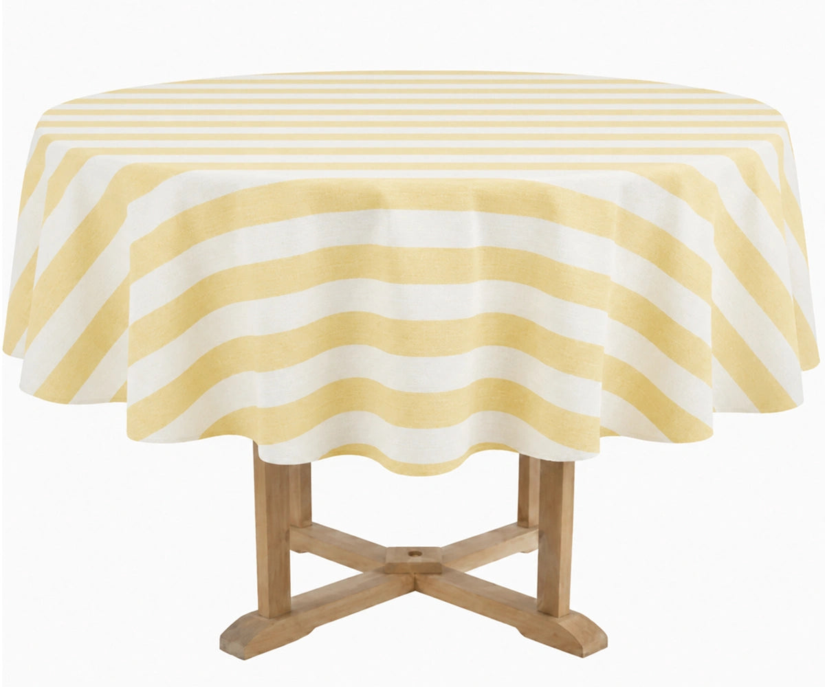A round table covered with a butter yellow and white striped tablecloth, supported by a light wood pedestal table, isolated on a white background. A round table covered with a butter yellow and white striped tablecloth, supported by a light wood pedestal table, isolated on a white background.