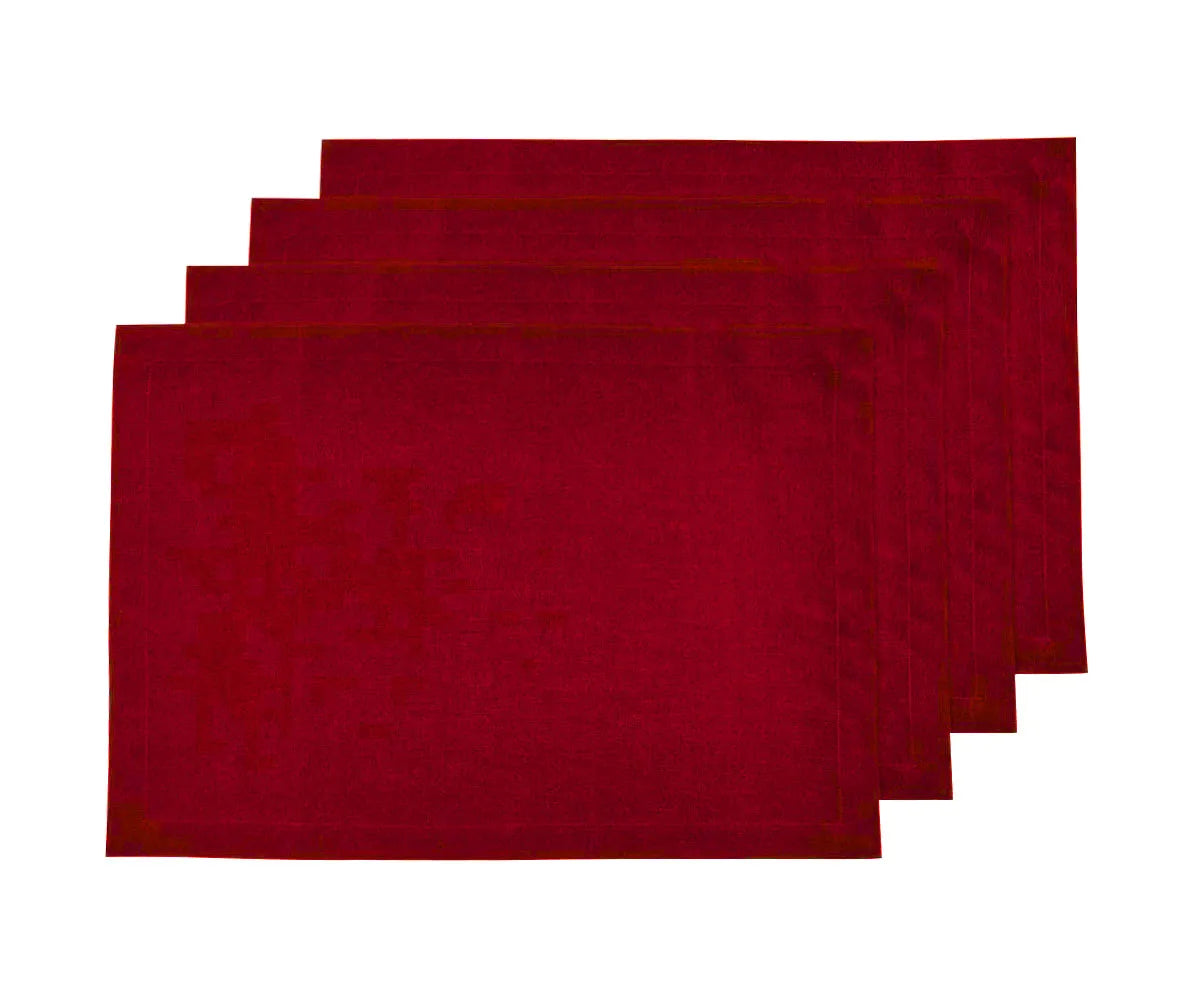 Cherry red linen placemats set on table Cherry red linen placemats set on table