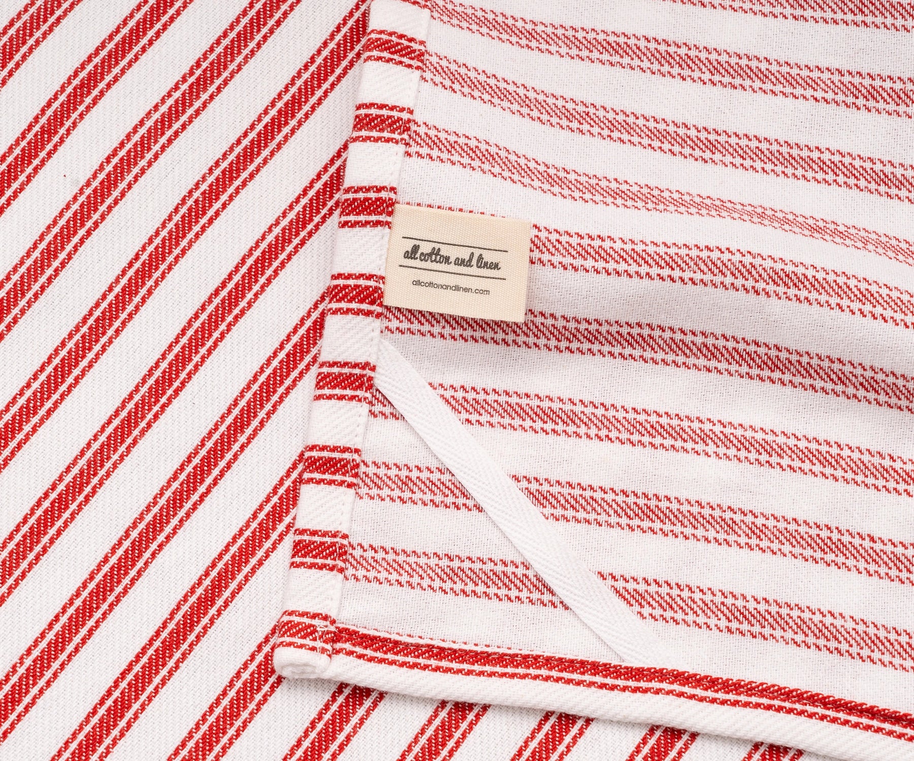 Round table covered with red and white cotton tablecloth Round table covered with red and white cotton tablecloth