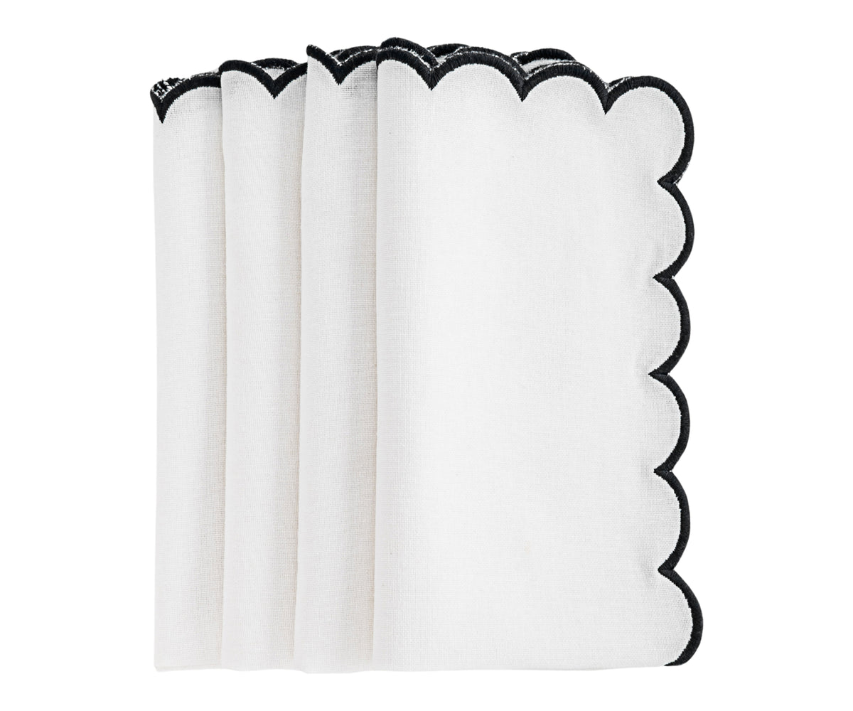 Decorative napkin with scalloped edges styled for a formal dinner. Decorative napkin with scalloped edges styled for a formal dinner.