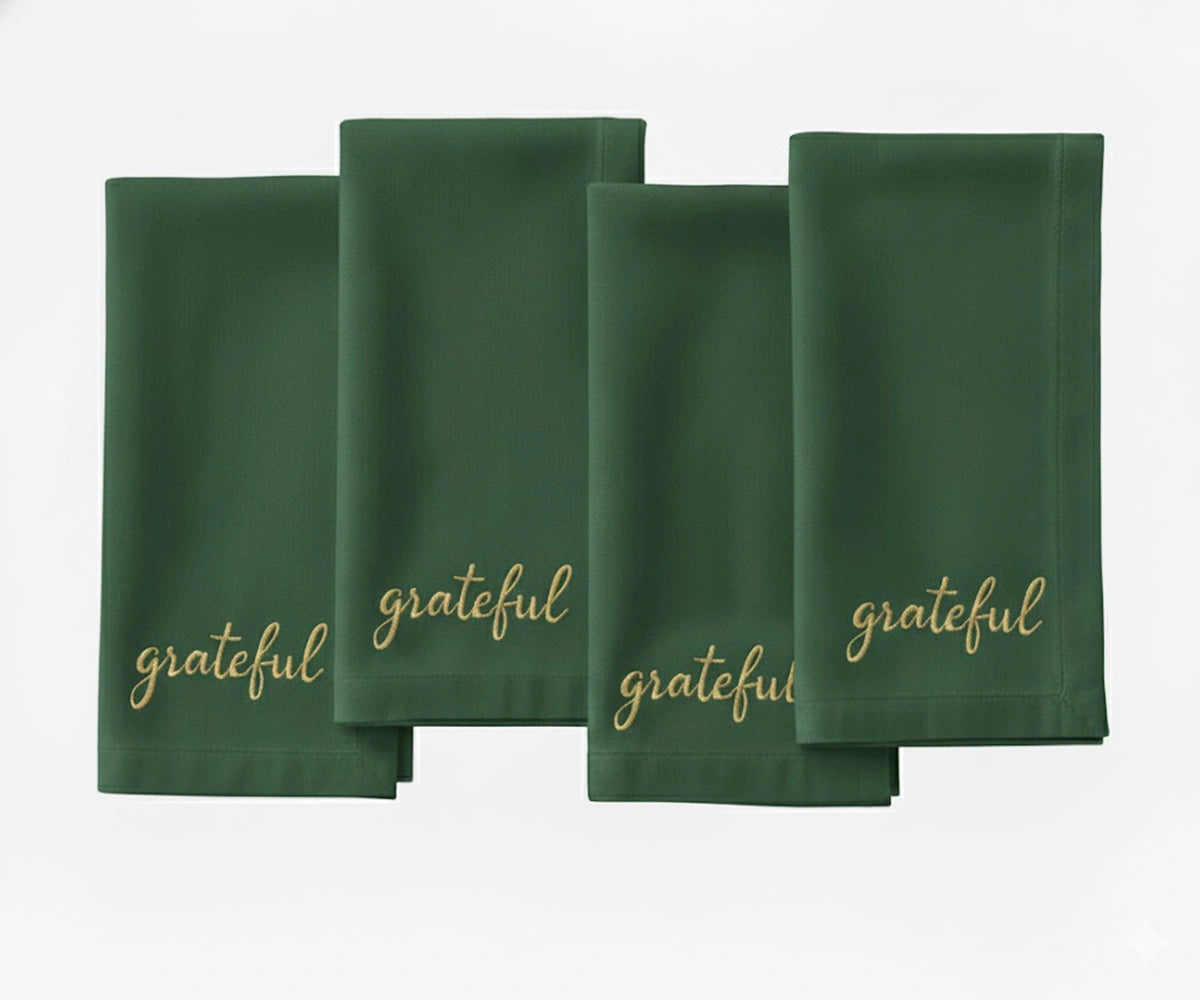 soft green cloth napkin featuring beige stitched “Grateful” message for dining décor. soft green cloth napkin featuring beige stitched “Grateful” message for dining décor.