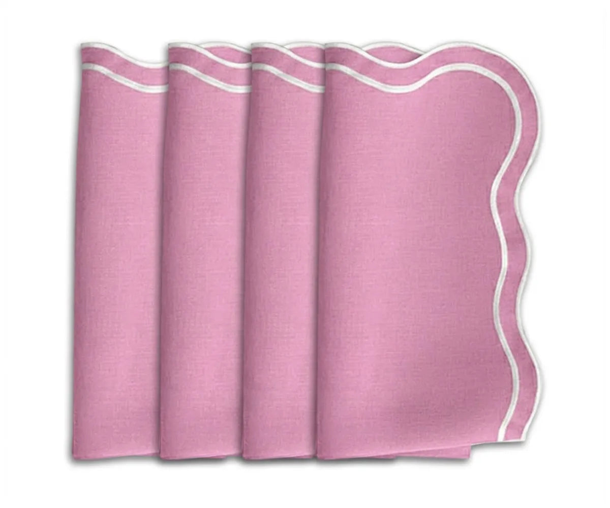 A set of pink cloth napkins with scalloped embroidered borders, neatly folded and displayed. A set of pink cloth napkins with scalloped embroidered borders, neatly folded and displayed.