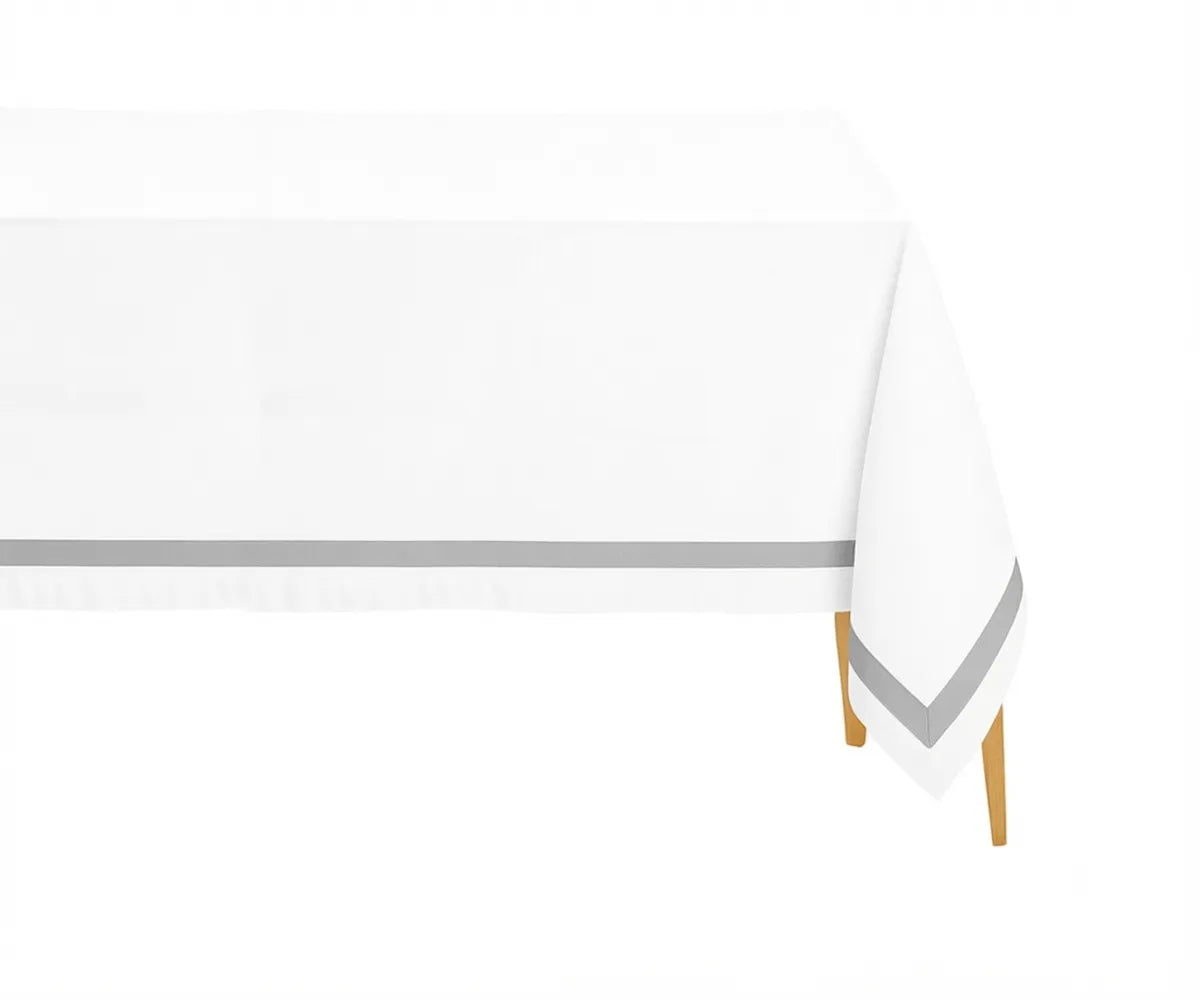White 100% cotton rectangle tablecloth with an elegant Lunar satin border on a dining table White 100% cotton rectangle tablecloth with an elegant Lunar satin border on a dining table