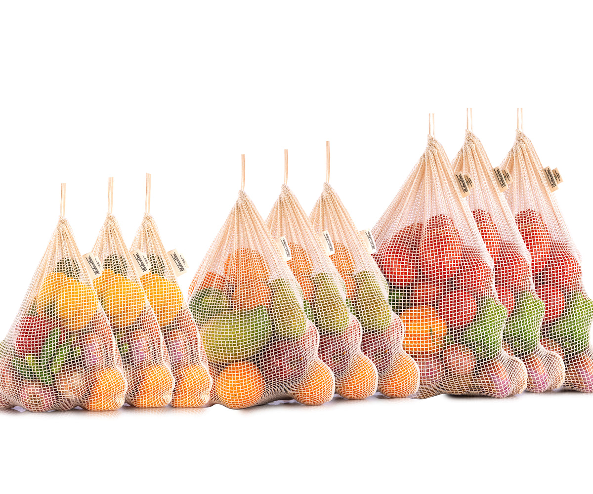 Multiple reusable mesh bags showcasing a variety of fruits Multiple reusable mesh bags showcasing a variety of fruits