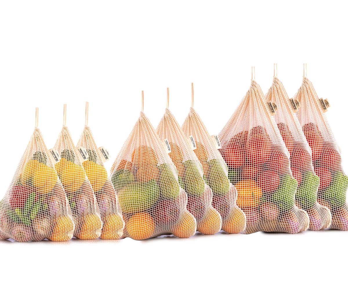 Multiple reusable mesh bags showcasing a variety of fruits Multiple reusable mesh bags showcasing a variety of fruits