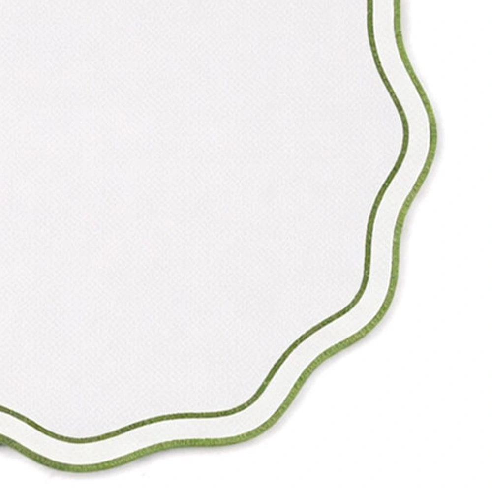 Embroidered sage green cotton round placemats with scalloped edges styled on farmhouse dining table for modern and minimalist décor Embroidered sage green cotton round placemats with scalloped edges styled on farmhouse dining table for modern and minimalist décor